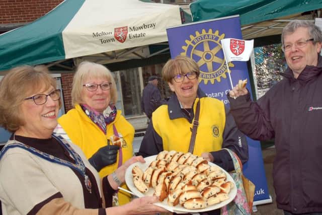 Senior Town Warden Dinah Hickling hands out hot cross buns with Melton Rotary members Helen Bett and Diana and Michael Osborne during Saturday's event EMN-170418-130506001