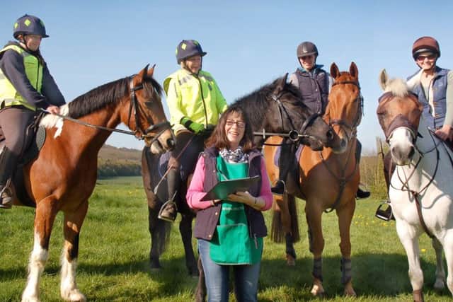 Christine Griffin sees a group of riders on their way PHOTO: Tim Williams