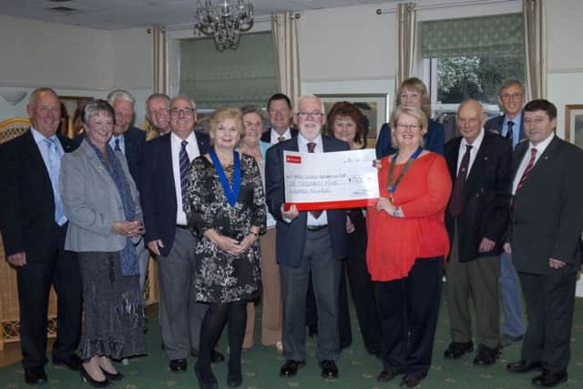 Sabrina Tate, Melton Mowbray Lions president presents cheque to John Craig, chairman of St Mary's Project Committee PHOTO: Derek Whitehouse