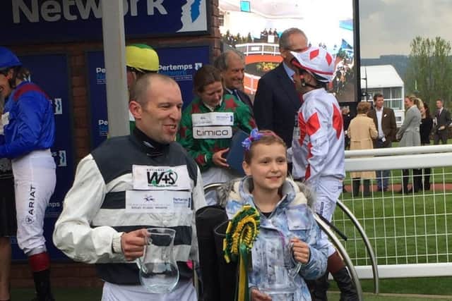 Melton soldier Ben Moore, who won a prestigious charity horserace at Cheltenham, pictured with daughter Grace at the meeting EMN-170421-101906001