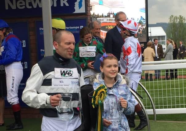 Melton soldier Ben Moore, who won a prestigious charity horserace at Cheltenham, pictured with daughter Grace at the meeting EMN-170421-101906001
