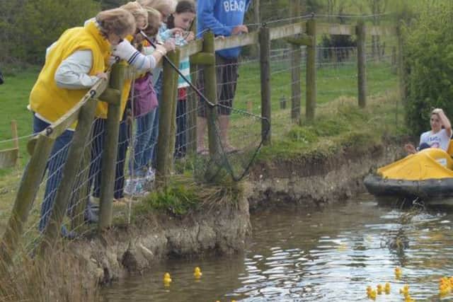 Spectators eagerly await the first ducks to touch the bank PHOTO: Supplied