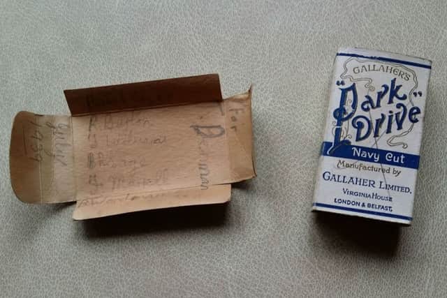 A cigarette packet written on and left by builders in the brickwork of a Melton house in July 1939 EMN-170205-111356001
