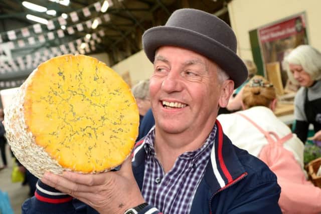 656463-09 : Â©Lionel Heap : News : 2017 Artisan Cheese Fair : Howard Lucas with a round of Cropwell Bishop Blue Shropshire. EMN-170205-095132001