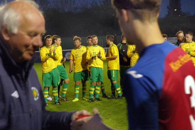 Holwell players look on as Leicester Road are presented with the Senior County Cup EMN-170305-123427002