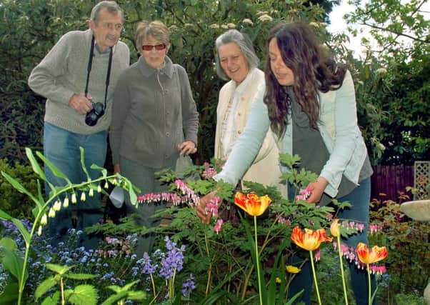 Owner Alison Blythe shows Alan and Carole Hewitt around the flower beds with horticultural expert Christina Moulton PHOTO: Tim Williams
