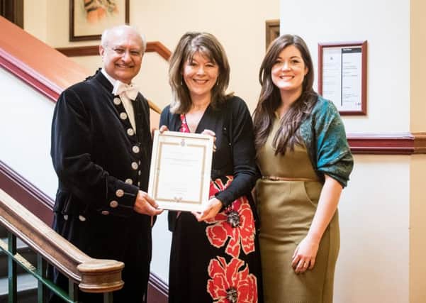 High Sheriff Professor Surinder Sharmer presents the award to Eluned Owen, pastor of Melton Vineyard Church (left) and Caroline Webb, Storehouse coordinator PHOTO: Gary Summers