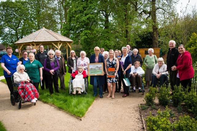 Staff and residents at The Amwell gather for tree planting PHOTO: Hazel Paterson Photography