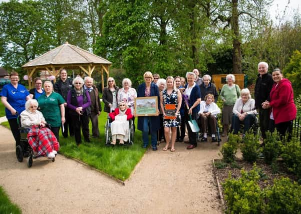 Staff and residents at The Amwell gather for tree planting PHOTO: Hazel Paterson Photography