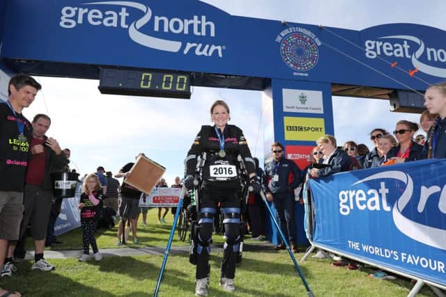 Claire Lomas crosses the finish line in her robotic suit during the Great North Run in Newcastle EMN-171005-165651001