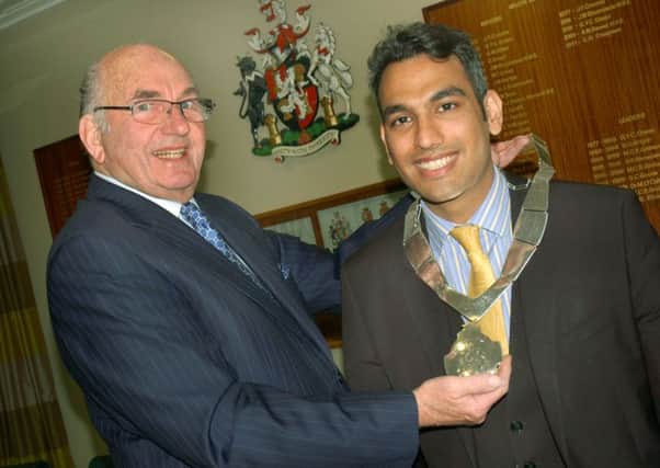New Mayor of Melton, Councillor Tejpal Bains, is handed the chains of office by outgoing Mayor, Councillor David Wright EMN-170516-112738001