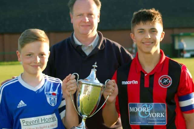 Secretary of Melton and District Charity Cup Committee Alan Digby with Sileby captain Luke Barratt on the left, and Ben Marshall from Barrow EMN-170516-180154002