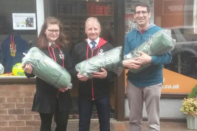 John Ferneley student Jess Seddon, the colleges Duke of Edinburgh Award scheme manager Danny OBrien and Melton Sports owner Michael Cooke with the expedition tents PHOTO: Supplied