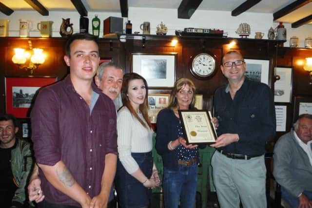 The Boat licensees Mick and Laura Jackson, along with their son Frazer and daughter Louise, are presented wiith a framed certificate by Melton CAMRA chairman Kevin Billson after being named Melton CAMRA pub of the Year 2017 EMN-170522-105040001