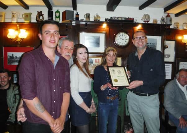 The Boat licensees Mick and Laura Jackson, along with their son Frazer and daughter Louise, are presented wiith a framed certificate by Melton CAMRA chairman Kevin Billson after being named Melton CAMRA pub of the Year 2017 EMN-170522-105040001