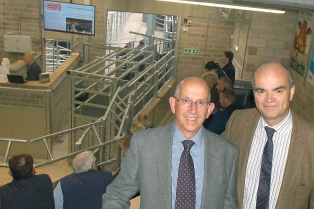 Steve Jeal (Melton NFU Mutual senior group secretary) and (right) Simon Fisher (NFU county advisor for Leicestershire, Northamptonshire and Rutland) prepare to watch the first auction in the new livestock building at Melton Cattle Market EMN-170523-160346001