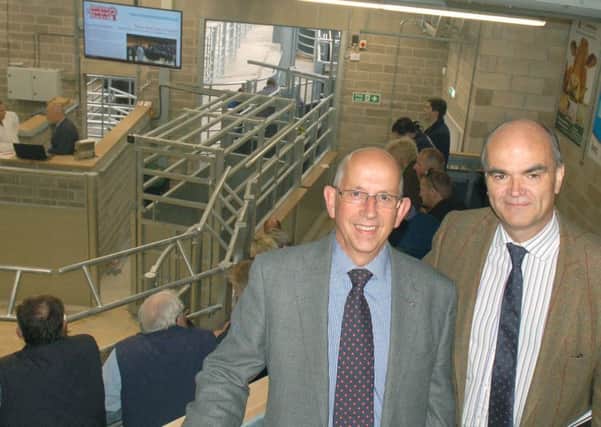 Steve Jeal (Melton NFU Mutual senior group secretary) and (right) Simon Fisher (NFU county advisor for Leicestershire, Northamptonshire and Rutland) prepare to watch the first auction in the new livestock building at Melton Cattle Market EMN-170523-160346001