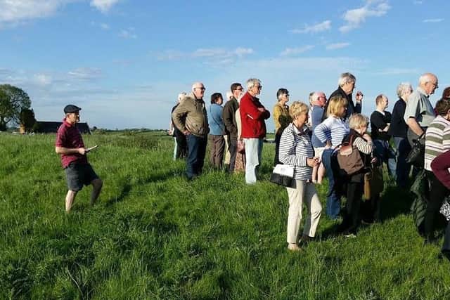 Local people are given a tour of a field adjacent to Welby Church where it is believed that remains of a Roman villa or a Danish settlement are buried under the surface EMN-170524-114442001