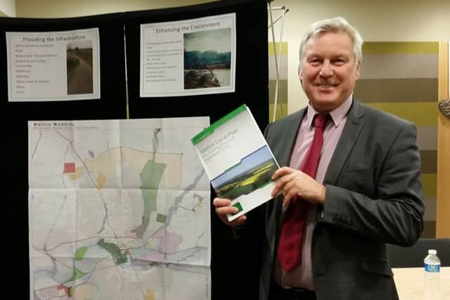 Jim Worley, Melton Council's head of regulatory services, hold a copy of Melton's draft Local Plan document at a public consultation event EMN-170706-145409001