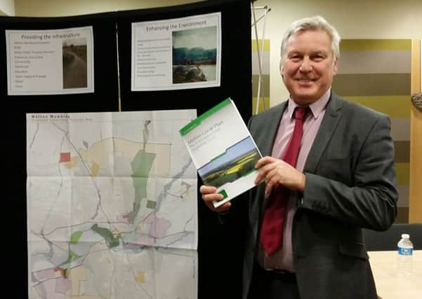Jim Worley, Melton Council's head of regulatory services, hold a copy of Melton's draft Local Plan document at a public consultation event EMN-170706-145409001