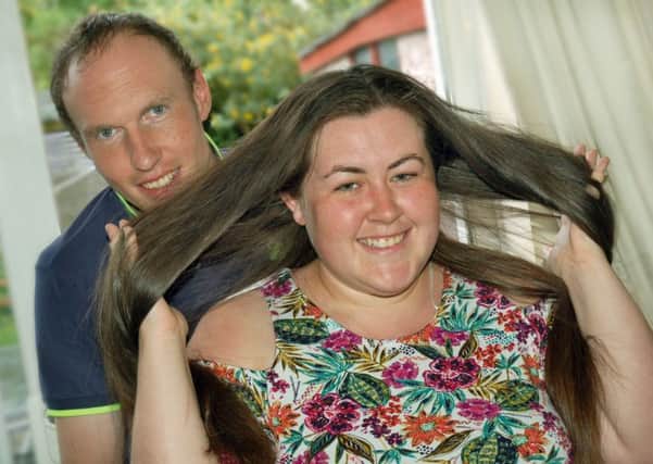 Bride-to-be Bethan Jones, who plans to have her hair cut off for charity the day after her wedding day, with fiancee James Cooke EMN-170506-150616001