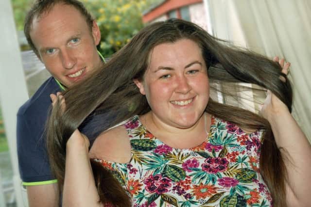 Bride-to-be Bethan Jones, who plans to have her hair cut off for charity the day after her wedding day, with fiancee James Cooke EMN-170506-150616001