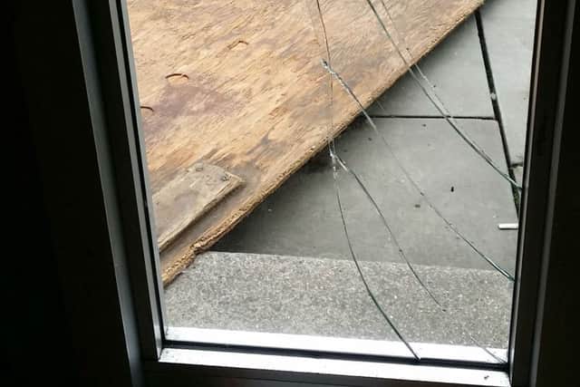 A smashed pane of glass at the front of the Melton Times office caused by a flying market stall in high winds in Melton this afternoon EMN-170606-161101001