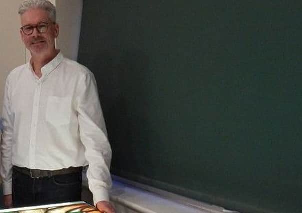 Derek Hunt with part of the new stained glass window for St Mary's Church PHOTO: Supplied
