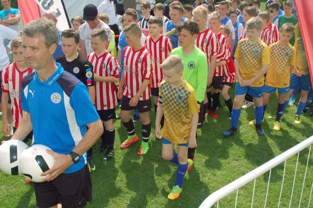 The teams parade onto the pitches for the start EMN-170706-160259002