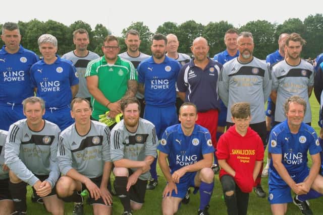 Chris Edwards (front,centre) lines up with the players before the kick-off in a charity match at Asfordby organised to raise money for the cancer ward which is treating his daughter, Jessica EMN-170613-180654001