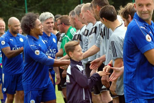 The players greet each other before Sunday's charity match at Asfordby EMN-170613-180741001