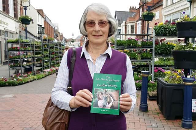 Ruth Harvey holds a copy of her book devoted to beloved daughter Caroline who died following a riding accident EMN-170616-130647001
