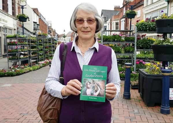 Ruth Harvey holds a copy of her book devoted to beloved daughter Caroline who died following a riding accident EMN-170616-130647001
