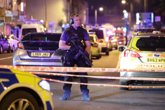 An armed police officer at a cordon in Seven Sisters Road, Finsbury Park. Picture: PA