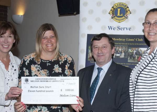 Surestart representatives receiving a cheque from Lion Geoff Tate PHOTO: Supplied
