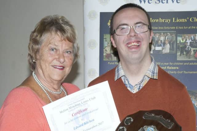 Edward Kitchen receiving his Achievement and Endeavour Award from Lion Maddie Smith