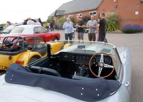 Spectators enjoy a drink whilst admiring the cars on display PHOTO: Supplied