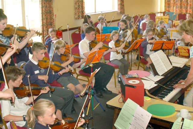 Music teacher Zosia Cocker conducts the children during their Violins in the Vale production last year PHOTO: Tim Williams