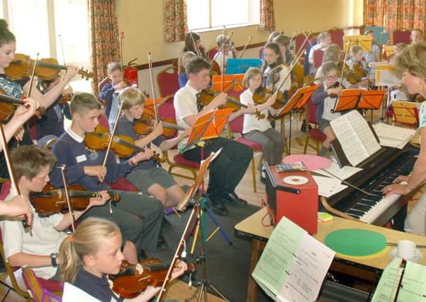 Music teacher Zosia Cocker conducts the children during their Violins in the Vale production last year PHOTO: Tim Williams