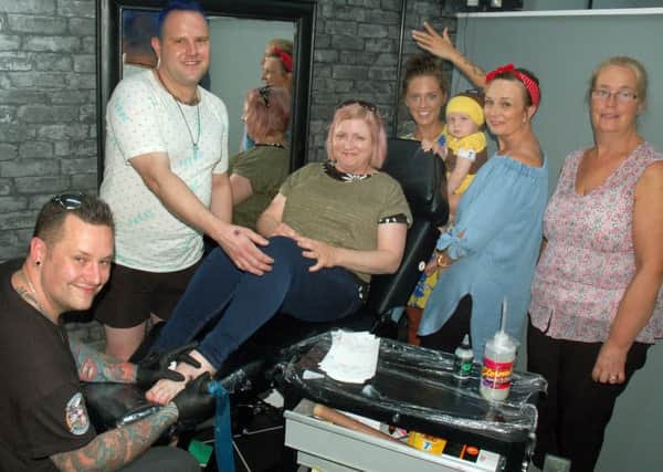 Tattooist and shop owner Chris Greaves with Egerton Lodge staff who had Manchester Bee tattoos done at the Cre8tive Ink studio in Melton to raise money for the appeal following the recent terrorist bombing EMN-170626-125242001