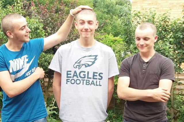 Three friends react to having their heads shaved for charity, from left, Andrew Bennett, who has an incurable condition. Alex Baker and Sam Pit Miller EMN-170628-174544001