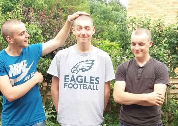 Three friends react to having their heads shaved for charity, from left, Andrew Bennett, who has an incurable condition. Alex Baker and Sam Pit Miller EMN-170628-174544001