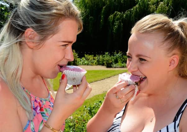 Amwell staff Lucy Fraser and Esme Little try cupcakes during National Cupcake Day PHOTO: SCS PR/The Amwell by John Robertson