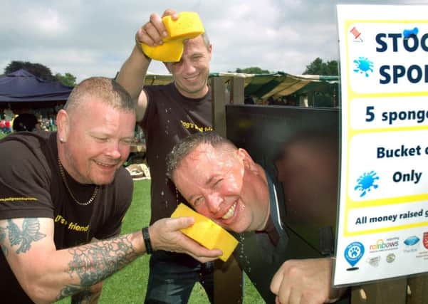 Tom Webster gets a sponge soaking from MARS work colleagues Alan Gregson and Richard Hill at the Party in the Park in Melton EMN-170407-115453001