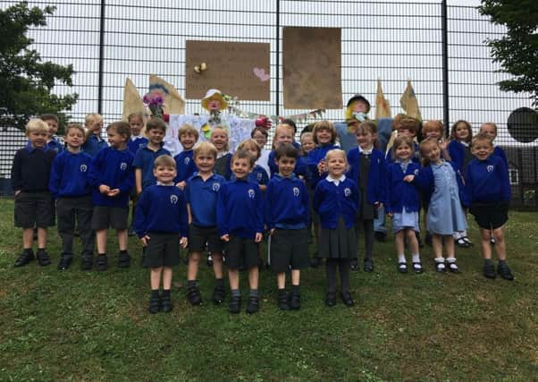 The class pose with scarecrows Harry OHay and Betty OBarley PHOTO: Supplied