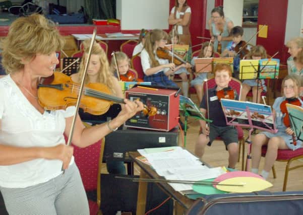 Zosia Cocker and local school violinists PHOTO: Tim Williams