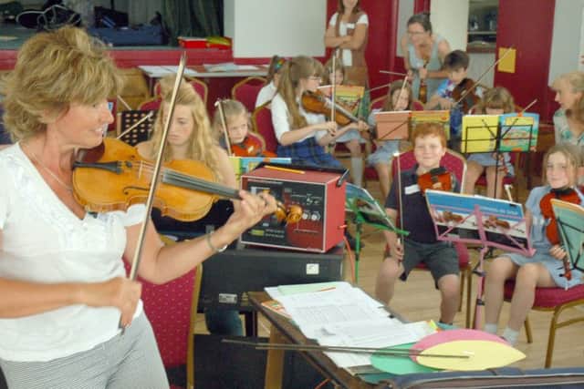 Zosia Cocker and local school violinists PHOTO: Tim Williams
