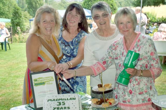 Committee members of Melton Mowbray Macmillan Cancer Support Group Di Orson, Christine Griffin, Margaret Ryder and Janet Gilchrist cut the celebration cake at their party PHOTO: Tim Williams