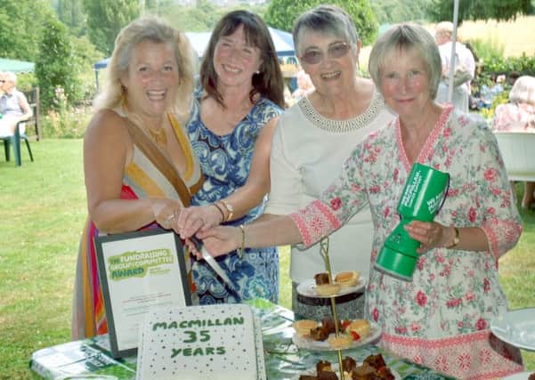Committee members of Melton Mowbray Macmillan Cancer Support Group Di Orson, Christine Griffin, Margaret Ryder and Janet Gilchrist cut the celebration cake at their party PHOTO: Tim Williams