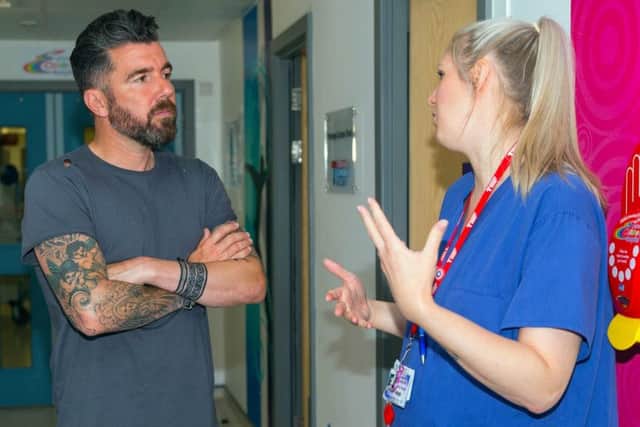 Deputy sister, Lyndsey Jackson, explains to Foxes' legend Muzzy Izzet how donations and charity events help Ward 27 at the LRI to offer the service they do. EMN-170607-164646001